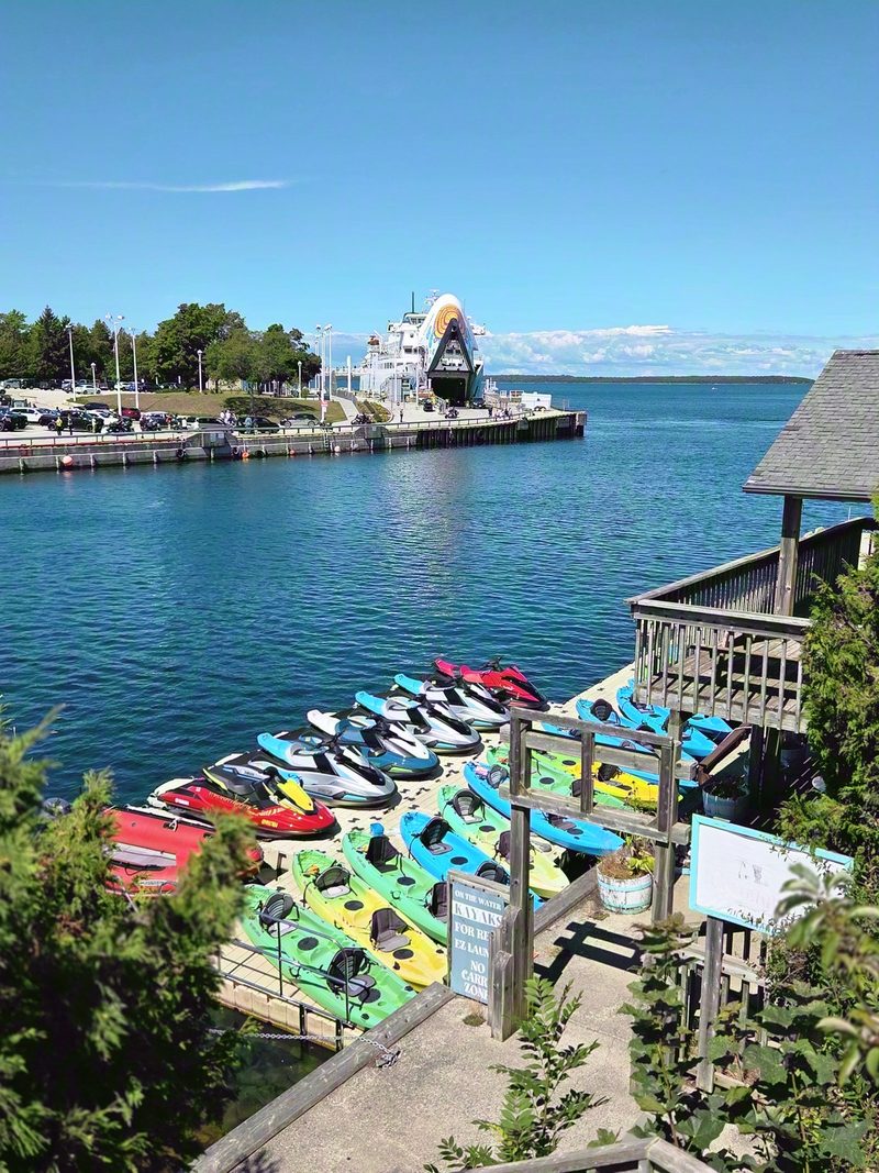 Little Tub Harbour from above with rental kayaks on the dock and the Chi-Cheemaun at the terminal with her bow door open