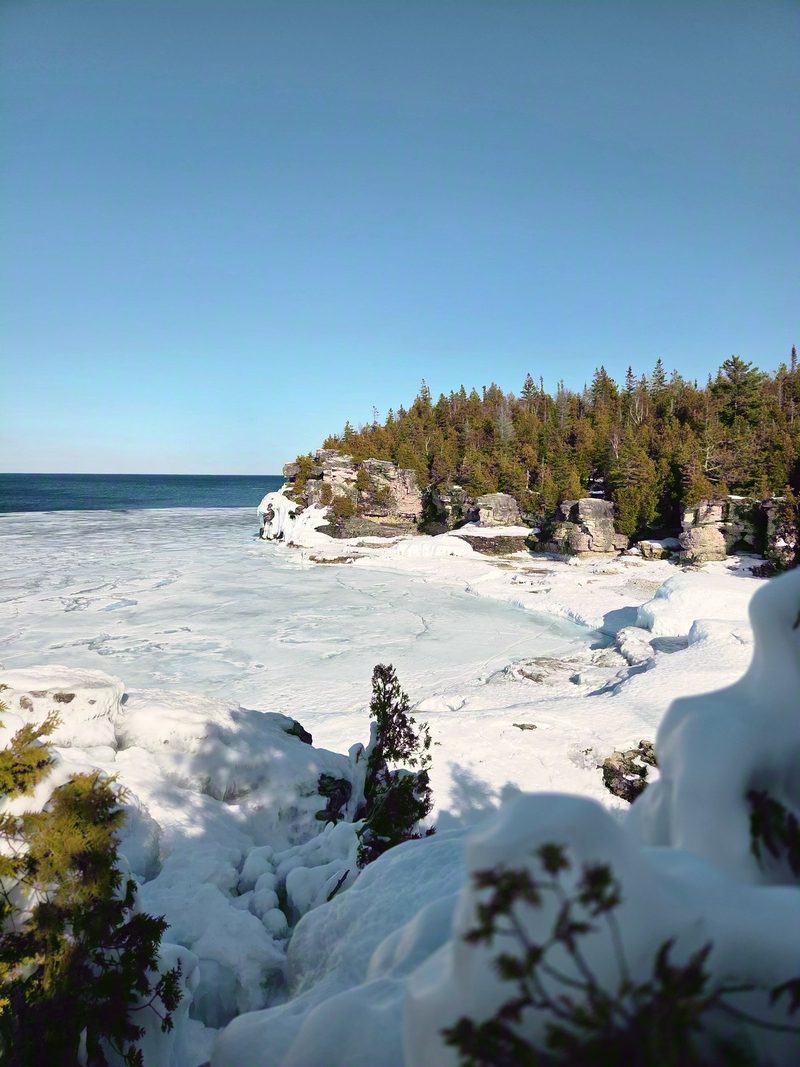 Georgian Bay frozen white from the clifftop with limestone headlands under deep snow