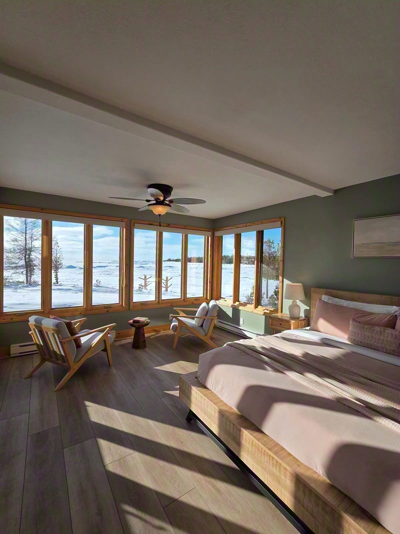 Winter sun casting long window shadows across Delfina's bed and sitting corner