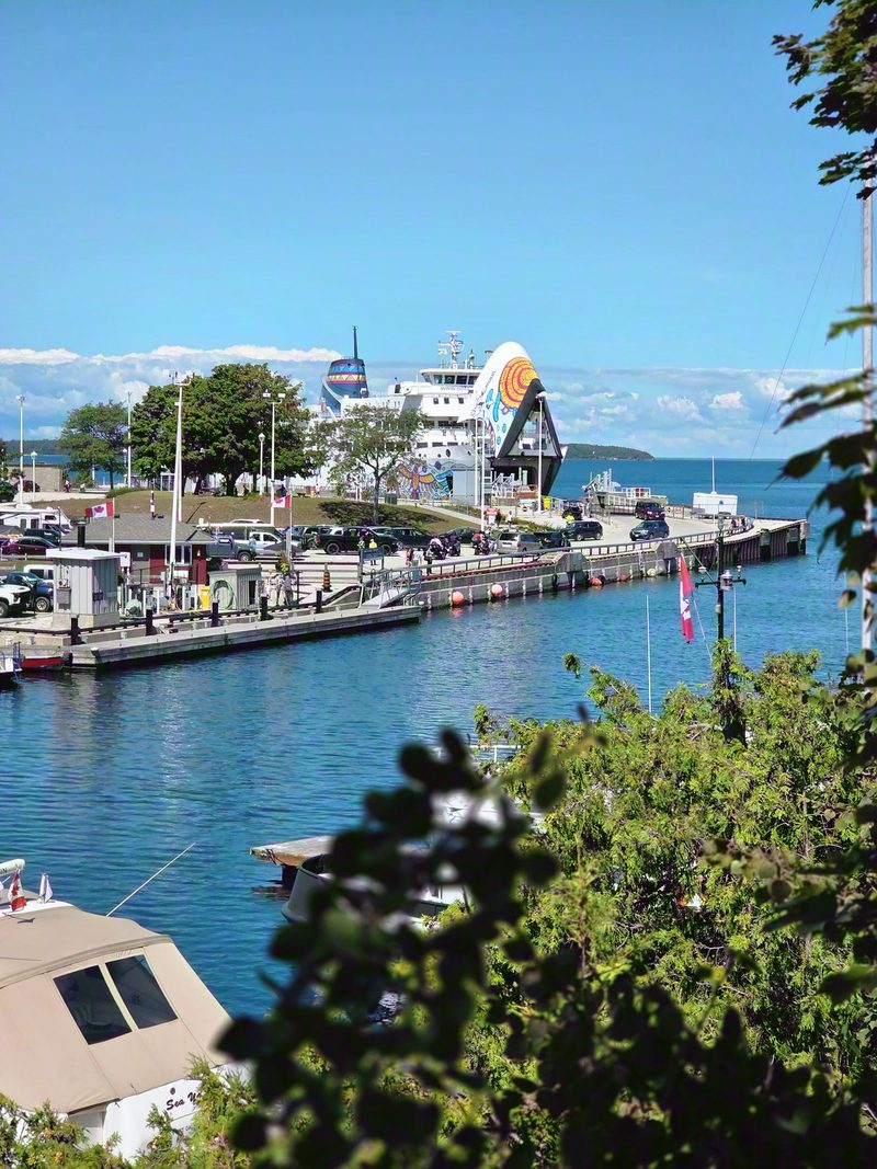 The MS Chi-Cheemaun at her Tobermory berth with the bow door raised, seen from above Little Tub Harbour