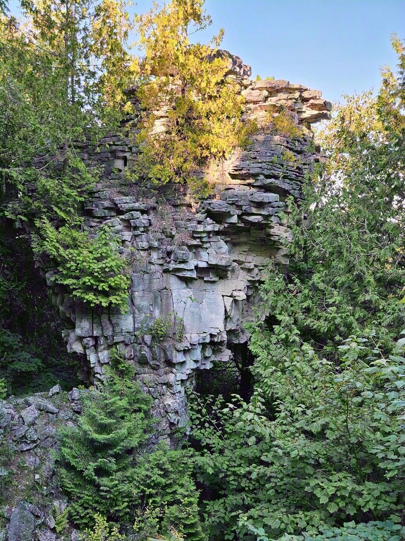The Devil's Monument, a 44-foot limestone flowerpot standing among ferns and cedars