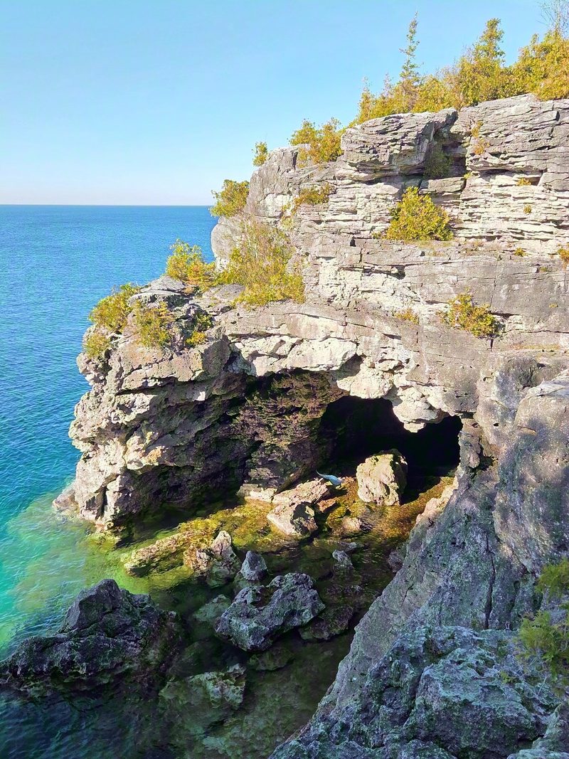 The Grotto's limestone cliff over turquoise water