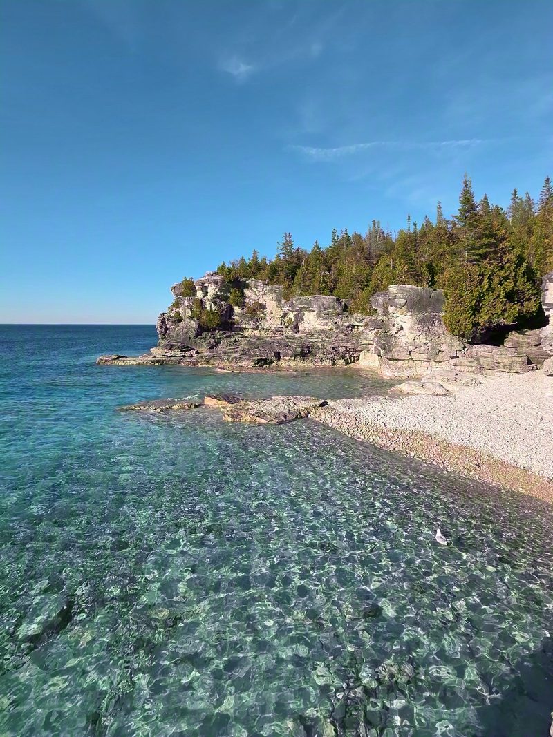 Crystal-clear shallows over white stone at the beach of Indian Head Cove