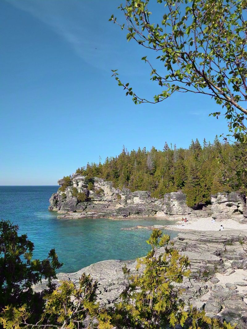 White limestone cliffs and clear turquoise water at Indian Head Cove in summer